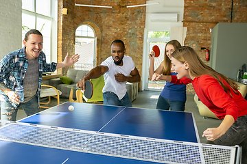 Image showing Young people playing table tennis in workplace, having fun