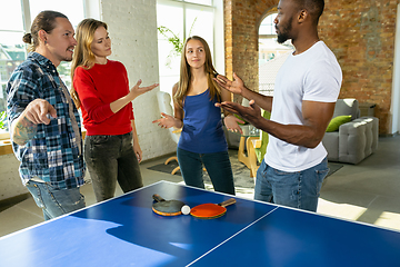 Image showing Young people playing table tennis in workplace, having fun