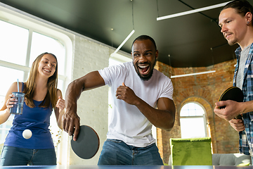 Image showing Young people playing table tennis in workplace, having fun