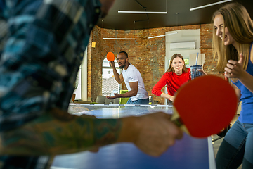 Image showing Young people playing table tennis in workplace, having fun