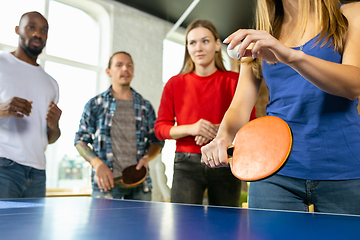 Image showing Young people playing table tennis in workplace, having fun