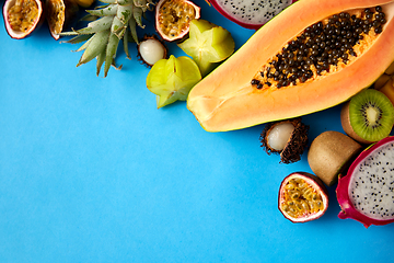 Image showing different exotic fruits on blue background