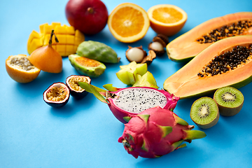 Image showing different exotic fruits on blue background