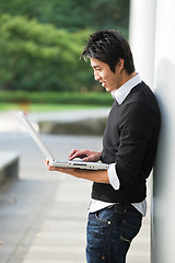 Image showing Asian student and laptop