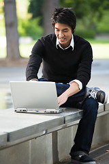 Image showing Asian student and laptop