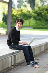 Image showing Asian student and laptop