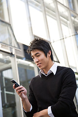 Image showing Asian man texting