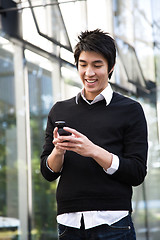 Image showing Asian man texting