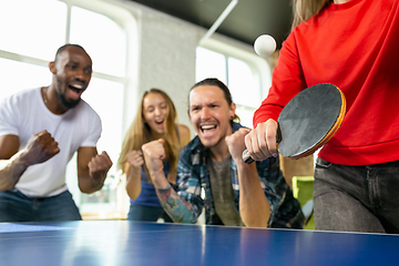 Image showing Young people playing table tennis in workplace, having fun