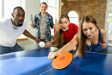 Image showing Young people playing table tennis in workplace, having fun