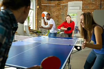 Image showing Young people playing table tennis in workplace, having fun