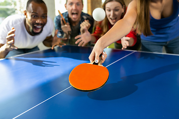 Image showing Young people playing table tennis in workplace, having fun