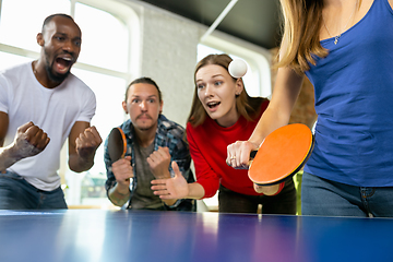 Image showing Young people playing table tennis in workplace, having fun