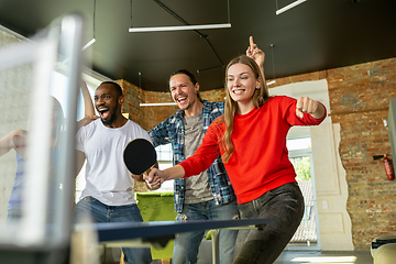 Image showing Young people playing table tennis in workplace, having fun