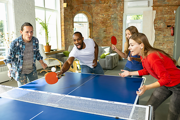 Image showing Young people playing table tennis in workplace, having fun