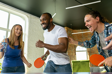 Image showing Young people playing table tennis in workplace, having fun