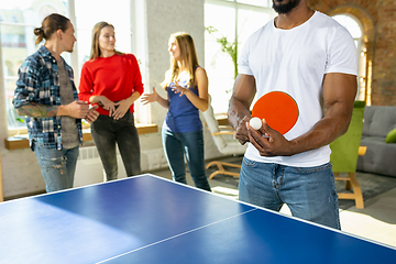 Image showing Young people playing table tennis in workplace, having fun