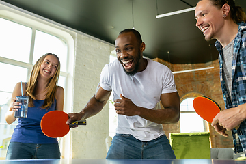 Image showing Young people playing table tennis in workplace, having fun