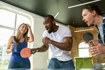 Image showing Young people playing table tennis in workplace, having fun