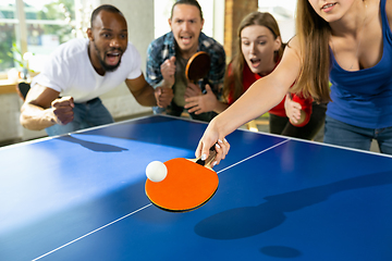 Image showing Young people playing table tennis in workplace, having fun