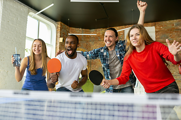 Image showing Young people playing table tennis in workplace, having fun