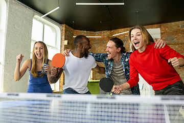 Image showing Young people playing table tennis in workplace, having fun