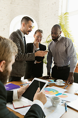 Image showing Group of young business professionals having a meeting, creative office