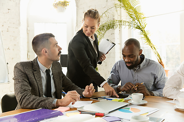 Image showing Group of young business professionals having a meeting, creative office