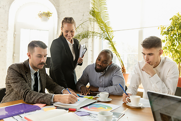 Image showing Group of young business professionals having a meeting, creative office