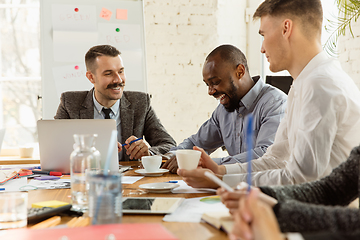 Image showing Group of young business professionals having a meeting, creative office