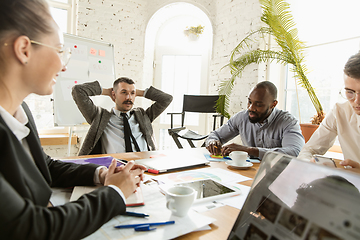 Image showing Group of young business professionals having a meeting, creative office