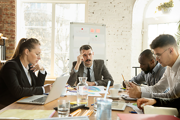 Image showing Group of young business professionals having a meeting, creative office