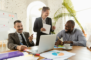 Image showing Group of young business professionals having a meeting, creative office