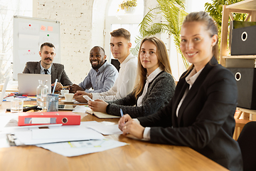 Image showing Group of young business professionals having a meeting, creative office