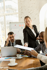 Image showing Group of young business professionals having a meeting, creative office