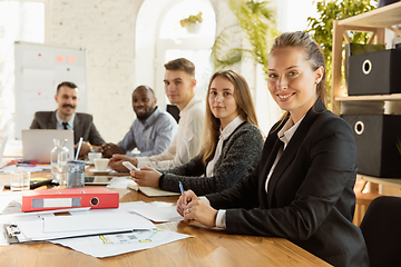 Image showing Group of young business professionals having a meeting, creative office