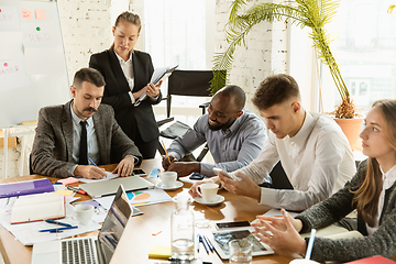 Image showing Group of young business professionals having a meeting, creative office