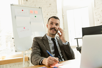 Image showing Young business professional preparing for meeting, creative office