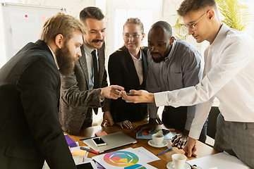 Image showing Group of young business professionals having a meeting, creative office