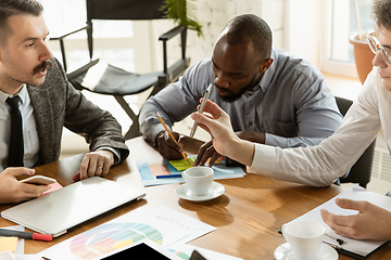 Image showing Group of young business professionals having a meeting, creative office