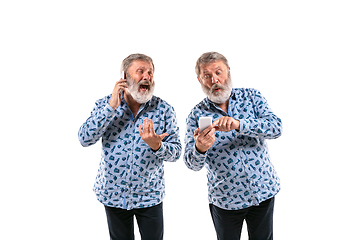 Image showing Senior man arguing with himself on white studio background.