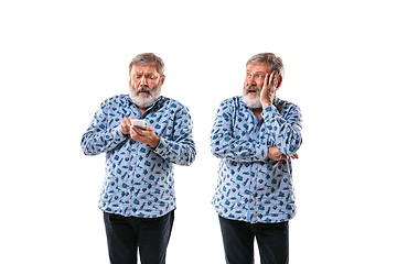 Image showing Senior man arguing with himself on white studio background.