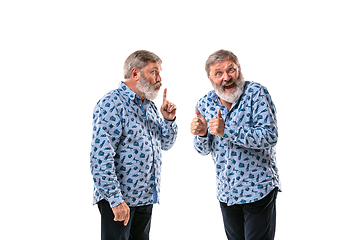 Image showing Senior man arguing with himself on white studio background.