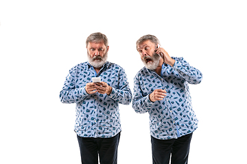 Image showing Senior man arguing with himself on white studio background.