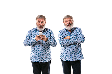 Image showing Senior man arguing with himself on white studio background.