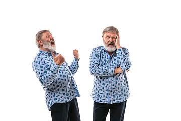 Image showing Senior man arguing with himself on white studio background.