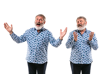 Image showing Senior man arguing with himself on white studio background.