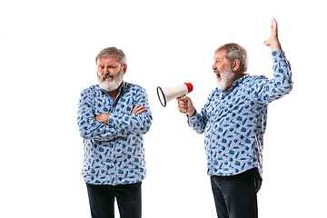 Image showing Senior man arguing with himself on white studio background.