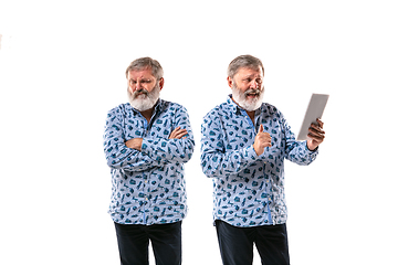 Image showing Senior man arguing with himself on white studio background.