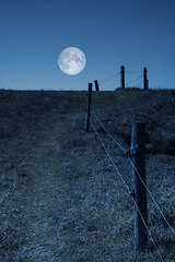 Image showing moon over a hill and a fence